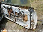 Bees in the door of a car in storage.