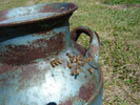 In an old milk can with a hole in it